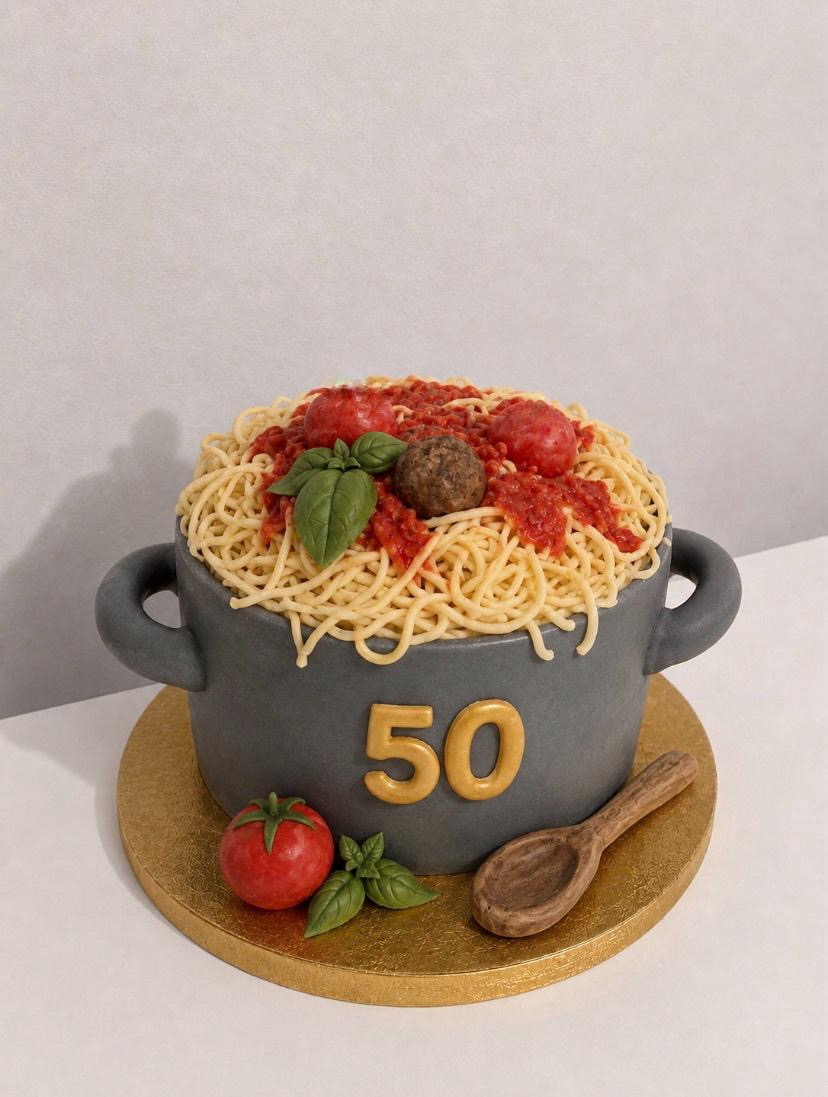 3D cake shaped like a cast-iron pot of spaghetti with tomato sauce and basil